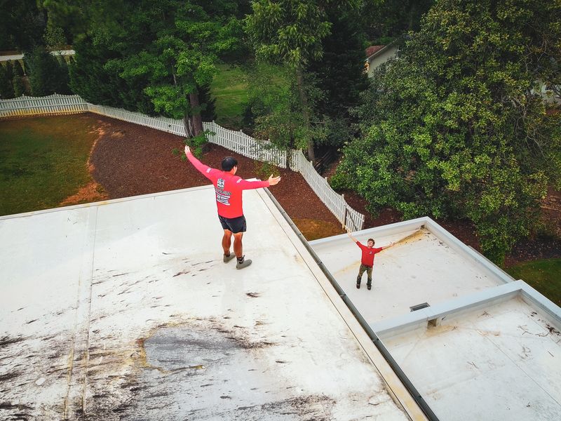 POW crew on a roof cleaning job